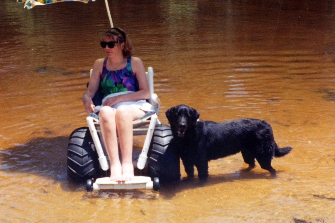 A day at Coldwater River in the second version of the DeBug Beach Wheelchair, with my dog Ruger around 1996