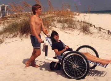 Mike pushing me in our very first beach wheelchair